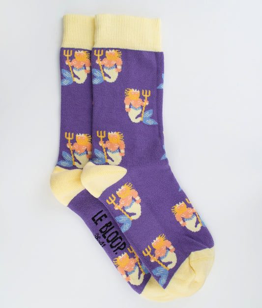 Chaussettes fantaisie violettes et jaune pastel en coton biologique à motif de Poseidons. Fabriquées en Europe, elles offrent un confort optimal grâce à leurs zones renforcées et leurs finitions plates sans couture.