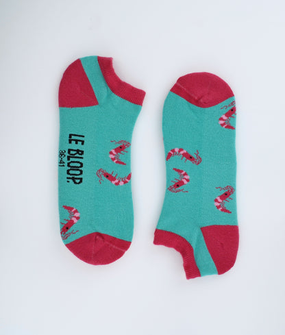 Socquettes fantaisie à motif de crevettes, inspirées de l'univers marin. Fabriquées en Europe en coton biologique, elles allient confort, douceur et originalité pour un style plein de caractère.